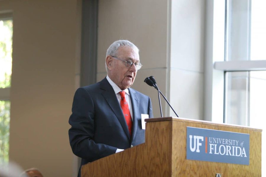 Bill Hough speaks at a podium during the dedication of Hough Hall