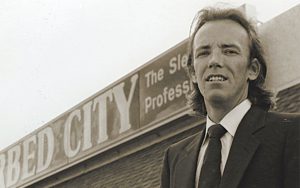 Kevin Koenig stands in front of a Waterbed City store. 