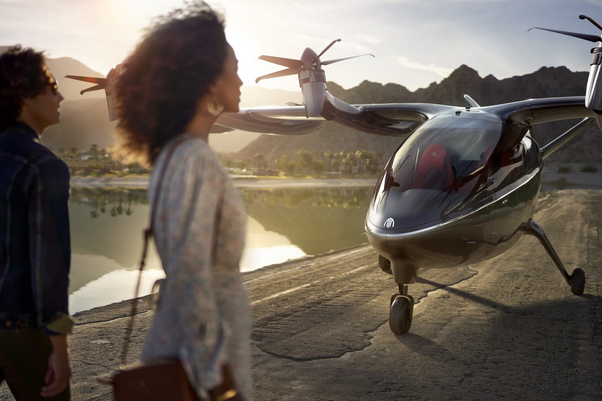 Two people standing in front of Archer's eVTOL. 