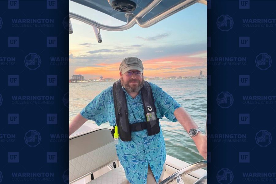 David P. Weber on a boat with water and orange sky behind him