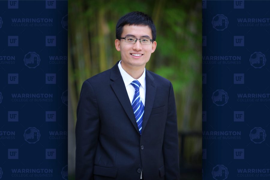 Liangfei Qiu in a business suit with a blue tie.