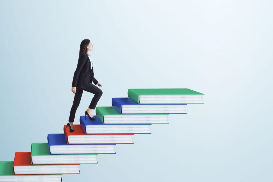 Businesswoman climbing book pile ladder. Sky background. Education and career concept