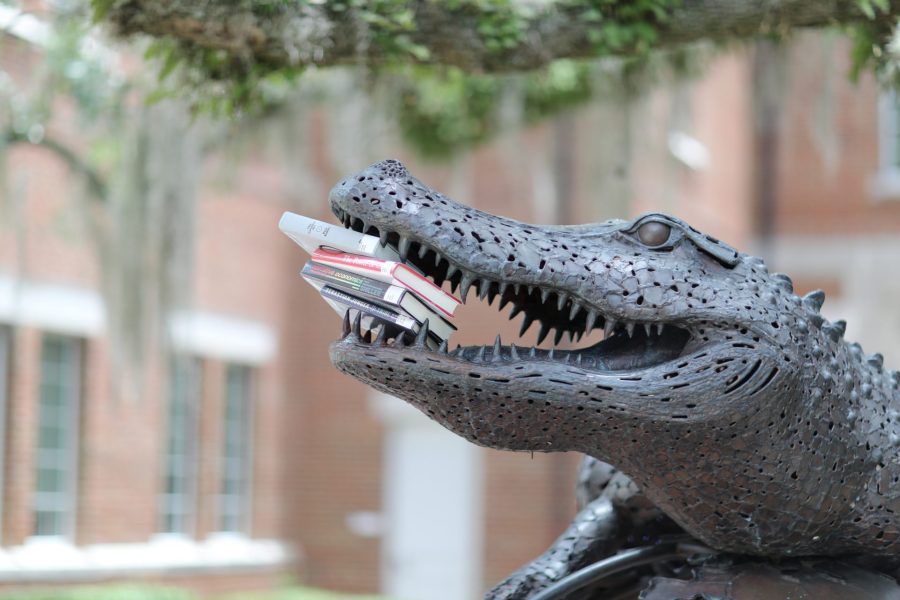 Large gator statue holds books in its open mouth