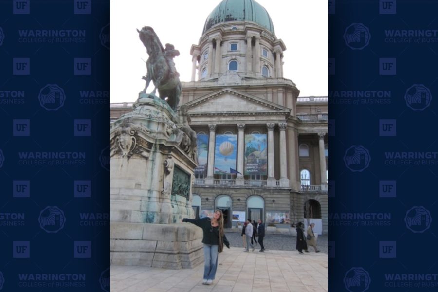 Mia Molinelli poses in front of a historic Hungarian building.