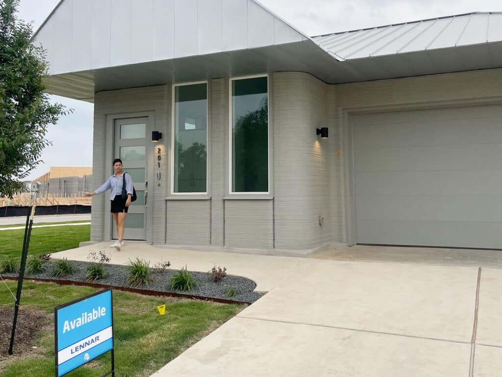 A person stands by the front door of a 3D home listed for sale by Lennar