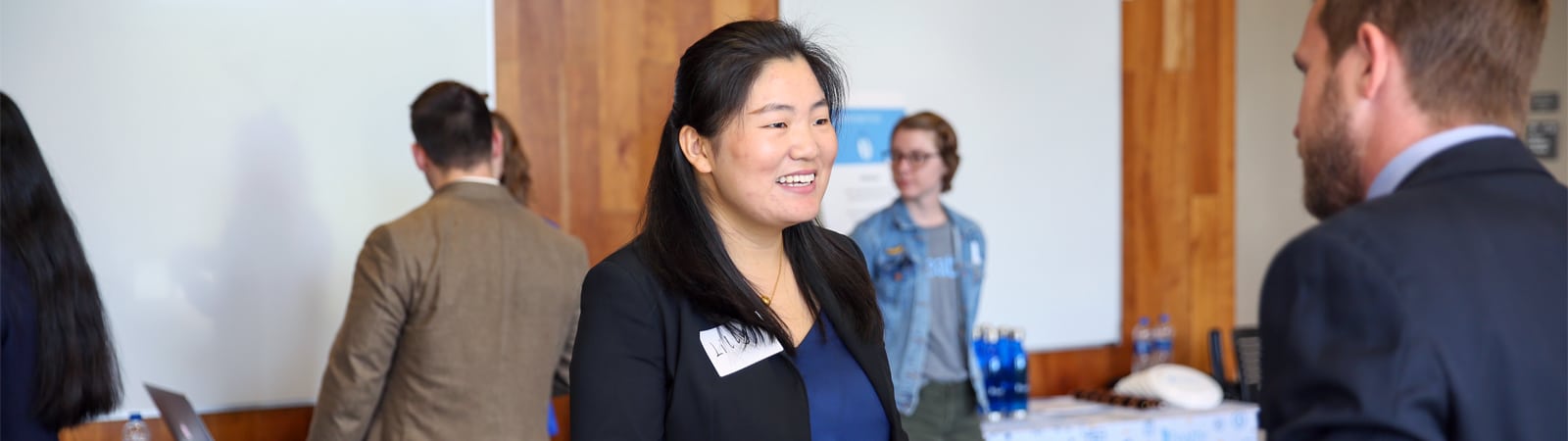 A student in professional attire speaks with a recruiter during a networking event at the Warrington College of Business.
