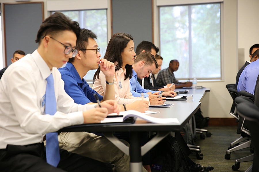 Students take notes during a class influenced by the UF Warrington College of Business' Bergstrom Real Estate Center