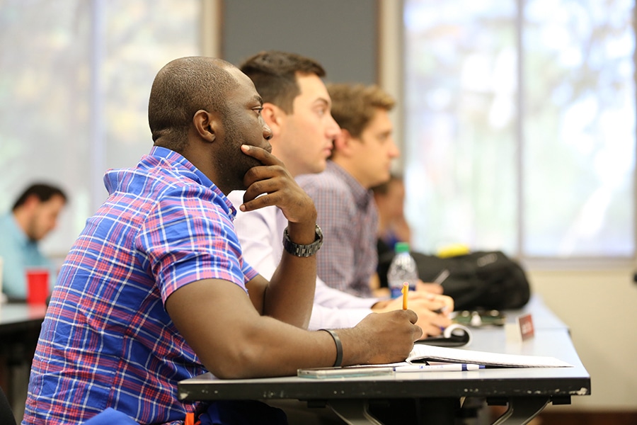 Students enrolled in the University of Florida Warrington College of Business' International Business combination degree program lean forward to watch a classroom presentation