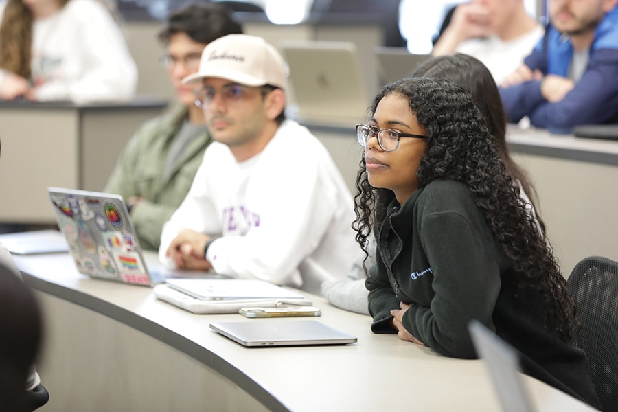 Students in a class for the University of Florida Warrington College of Business' MS Marketing program, including combination degree students, intently listen during a lecture