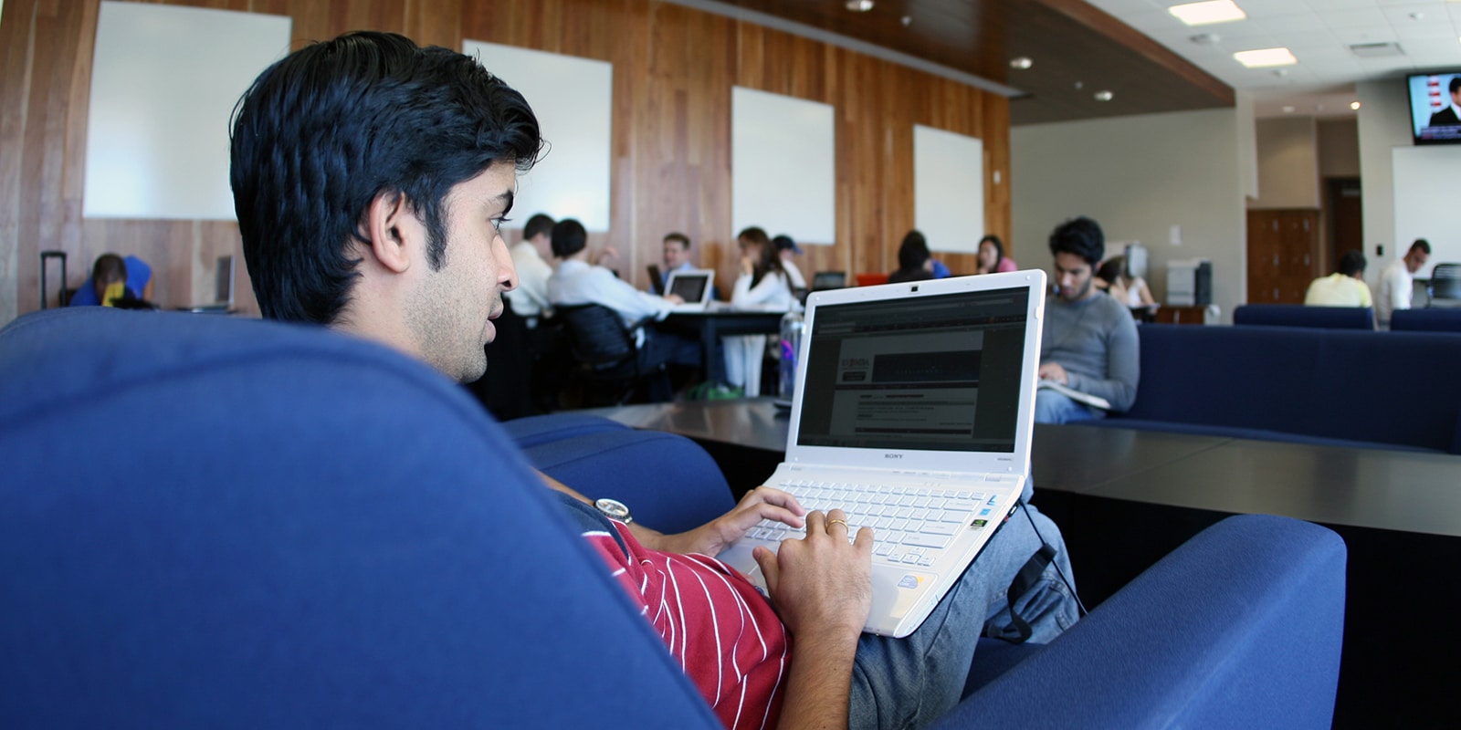 A student from University of Florida's Executive MBA program reviews a technical training course from a campus common area