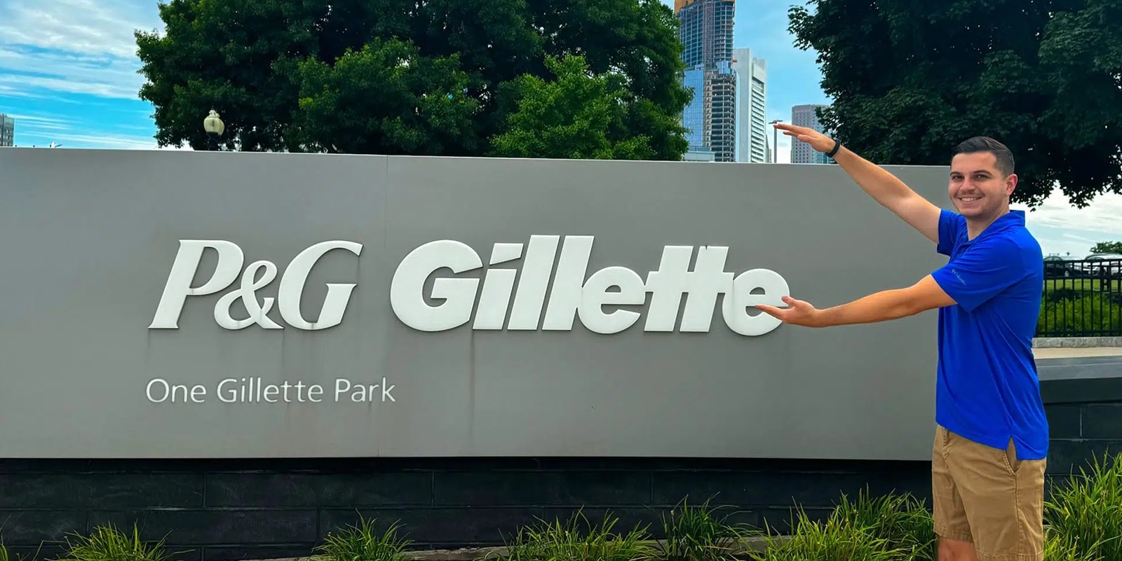 A student from University of Florida's Full-Time MBA program makes Gator arms outside Procter and Gamble during an internship