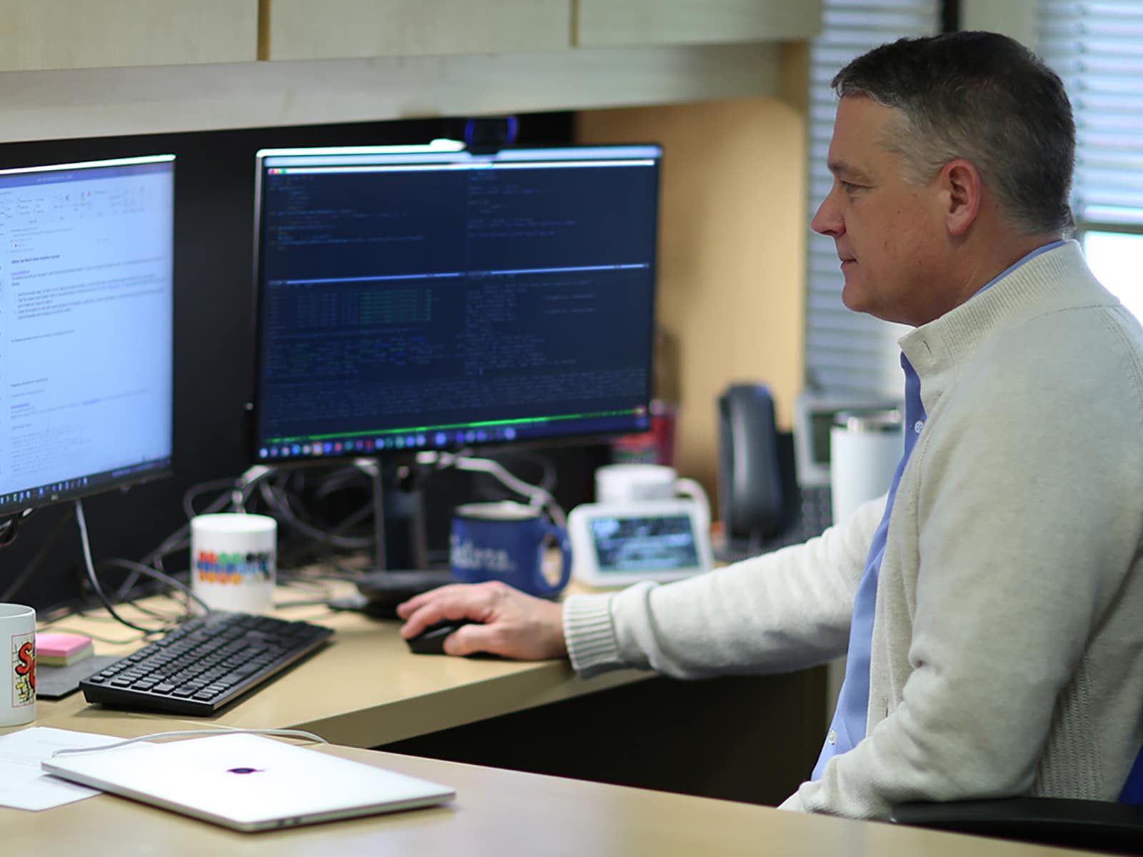 A researcher from the University of Florida Warrington College of Business reviews data from a study on two computer monitors