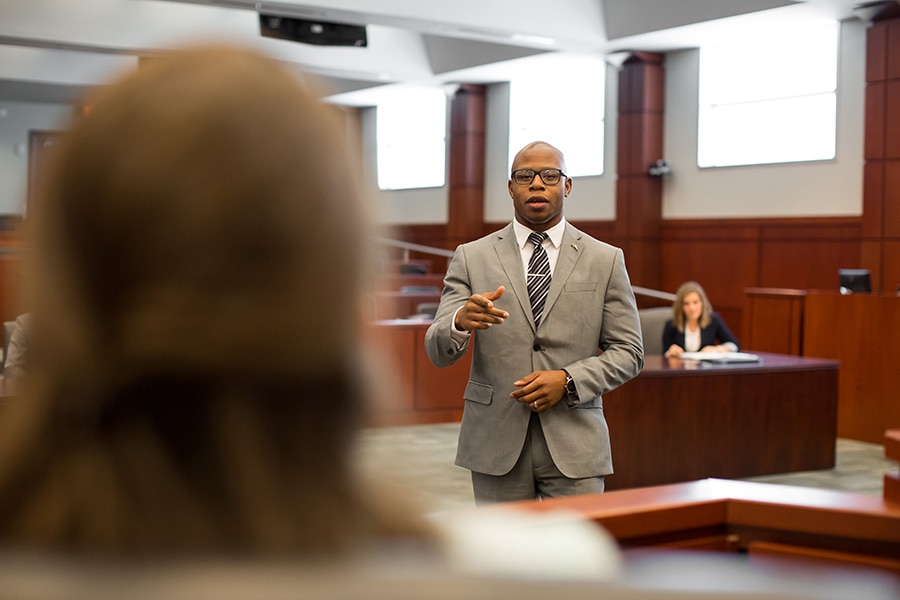 A student enrolled in the University of Florida Warrington College of Business' joint JD/MBA student practices his defense skills in a courtroom setting