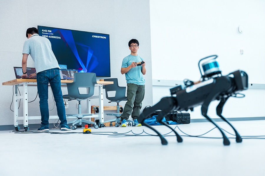 Using a computer and controller, students enrolled in the University of Florida MBA Engineering Partnership practice controlling a four-legged robot