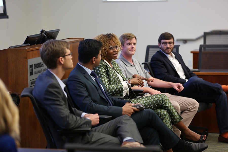 PhD and master's students enrolled in one of Warrington's joint degree programs have a discussion while sitting on chairs in a circle