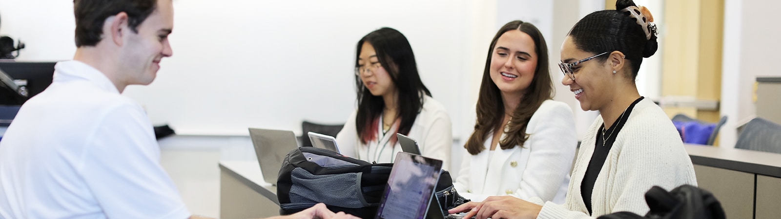A group of students participating in a joint master's degree program offered by the University of Florida Warrington College of Business hold a study session