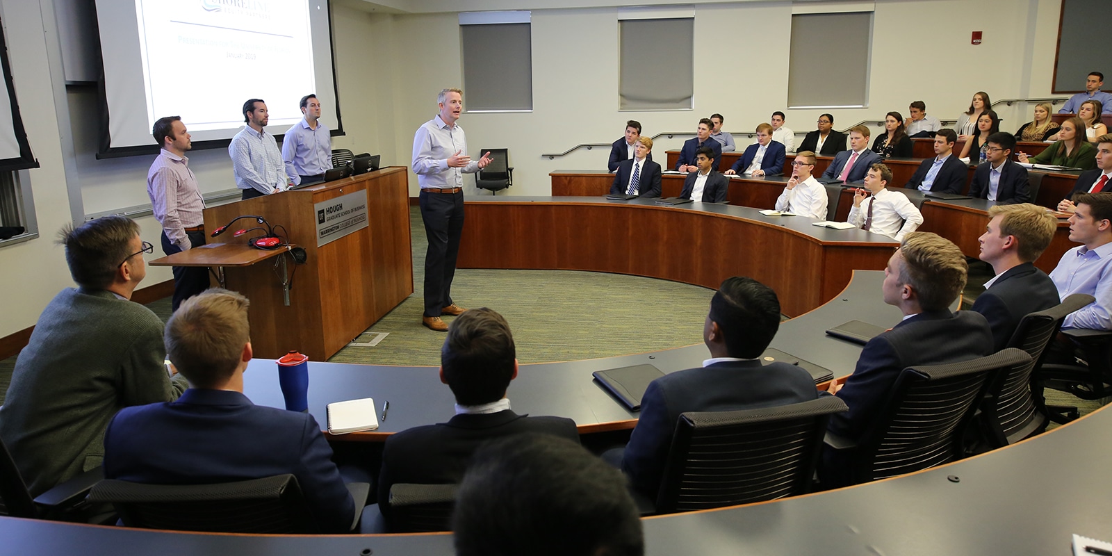 A group of finance professionals speak with students from the UF Warrington College of Business for the Finance Professional Speaker Series