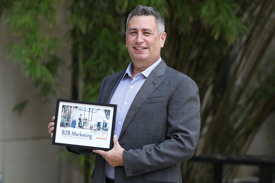 UF Warrington MS Marketing Instructor Michael A. Carrillo holding an award