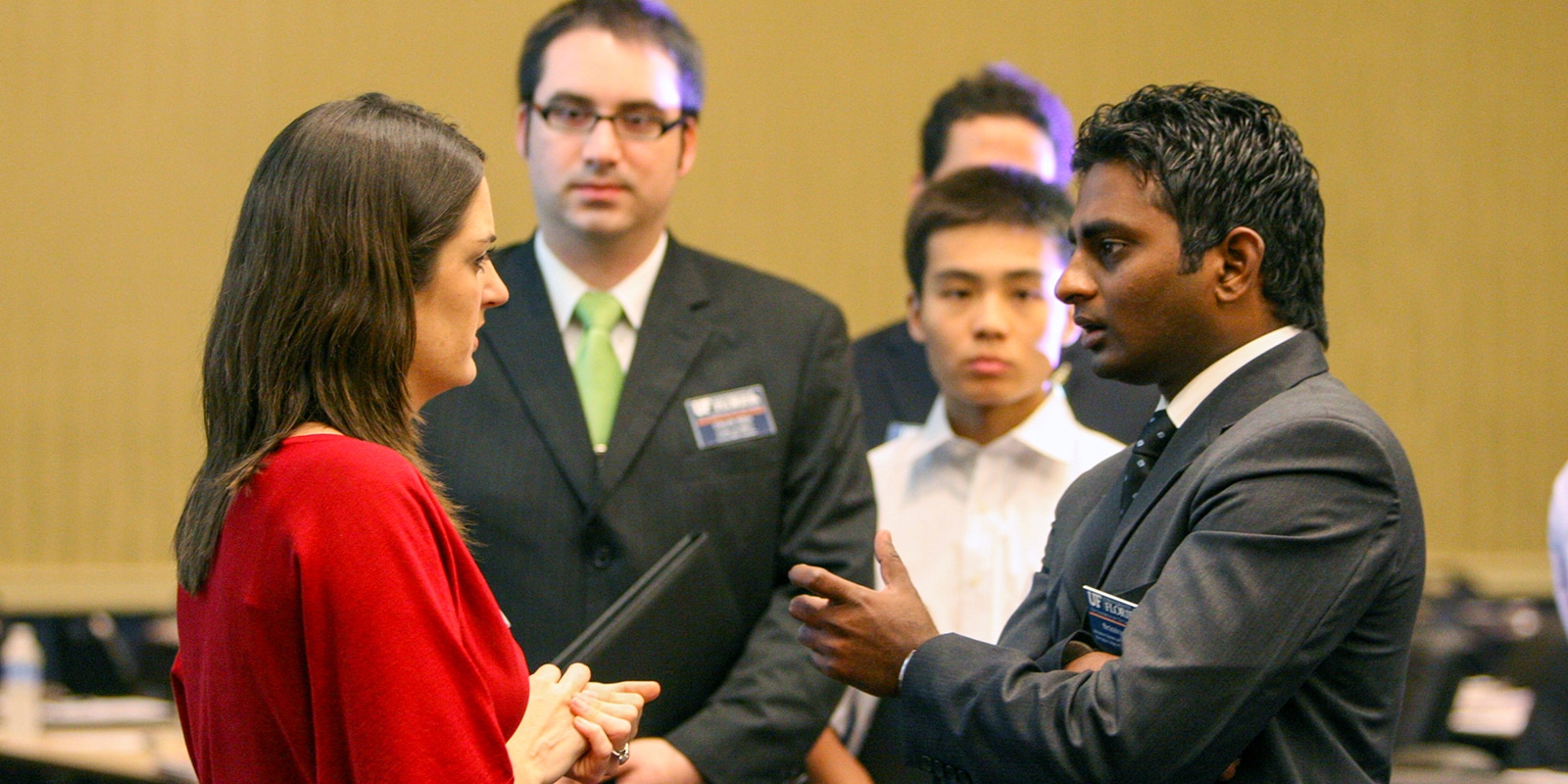 Students from the University of Florida's MBA programs learn about open positions from a recruiter at a campus career event