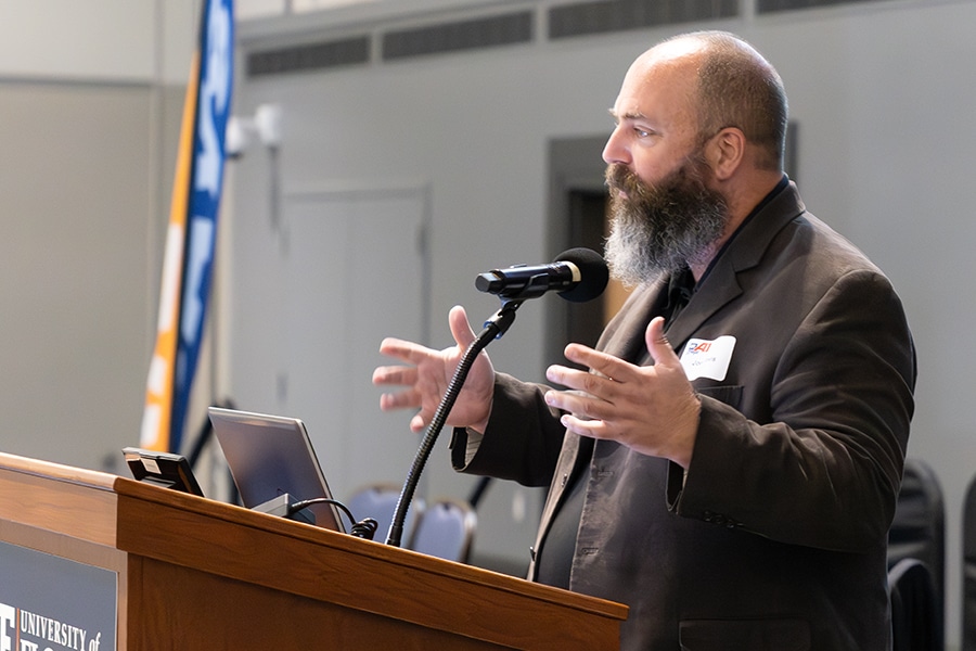 UF Warrington Online MBA Instructor Dr. Joel Davis lectures behind a podium