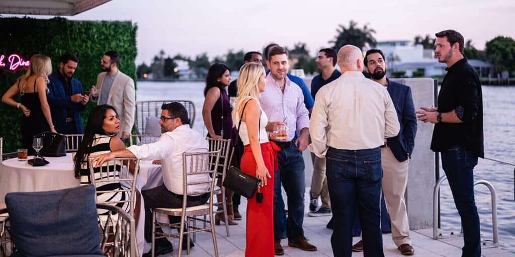 Students from UF Warrington's South Florida Weekend Part-Time MBA socialize during an outdoor networking event