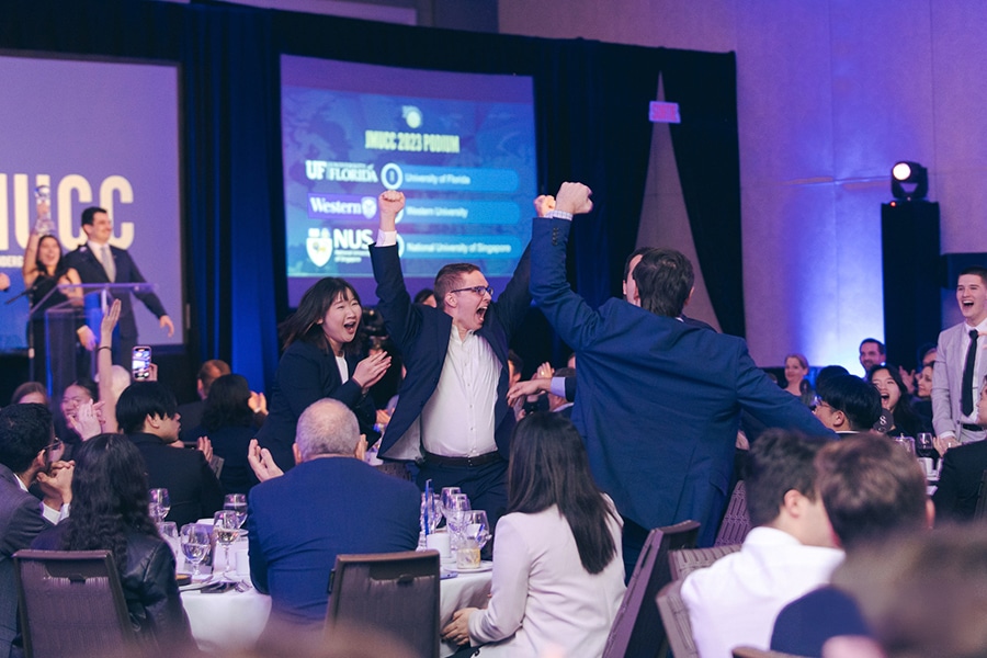 University of Florida Warrington College of Business students celebrate a case competition win, showcasing excitement at a ceremony.