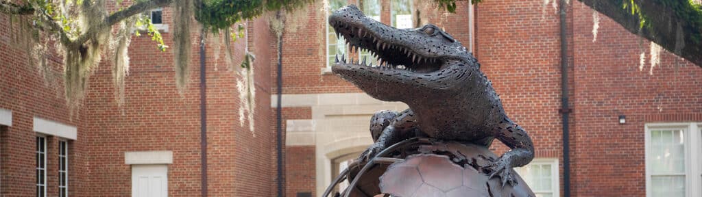 The Gator Ubiquity Statue (GUS) with Heavener Hall in the background.