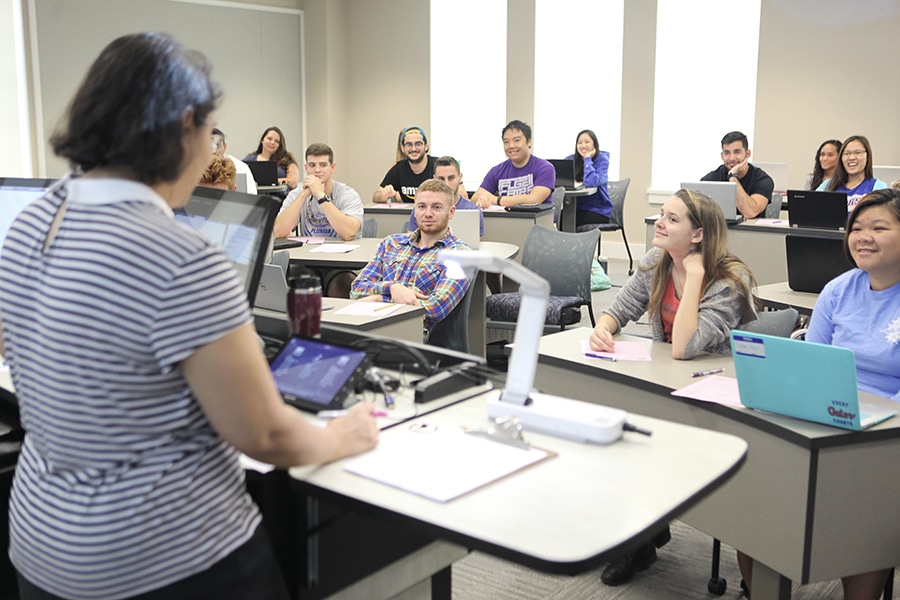 Group of students seated and listening to a lecture. 