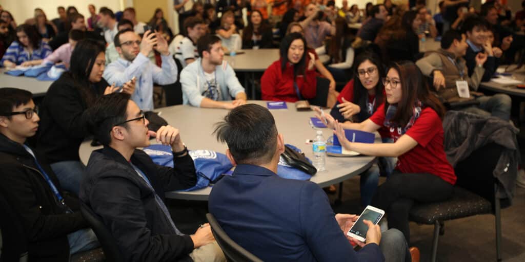 BABA and BSBA students from the UF Warrington College of Business strategize around a table during a case competition