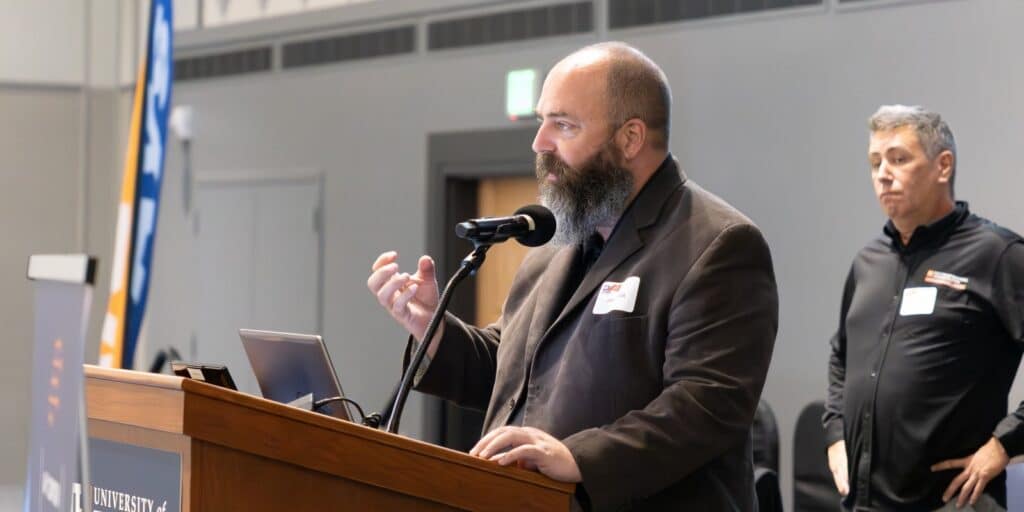 A professor lectures a class of BSBA in Information Systems students about data analytics and AI concepts and the opportunities available at UF Warrington College of Business