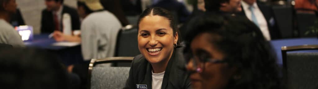 BSBA in Information Systems students smile and engage during an event held by the University of Florida Warrington College of Business