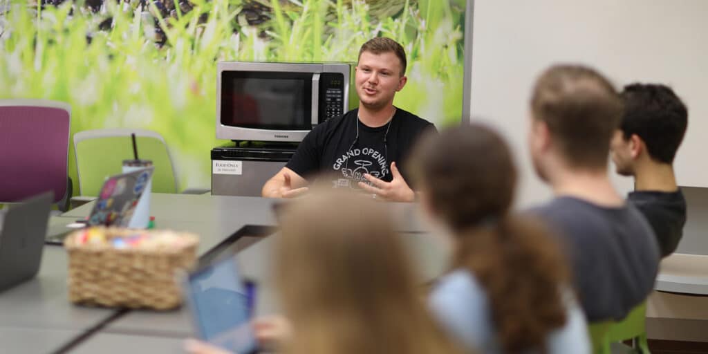 BSBA in Management students listen to a startup founder talk during a meeting hosted by UF Warrington's Entrepreneurship and Innovation Center