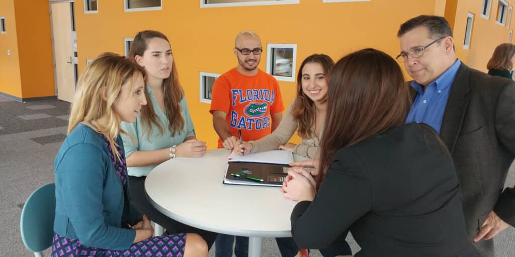 BSBA in Management students meet with industry partners around a table during an event sponsored by UF Warrington's Human Resource Research Center