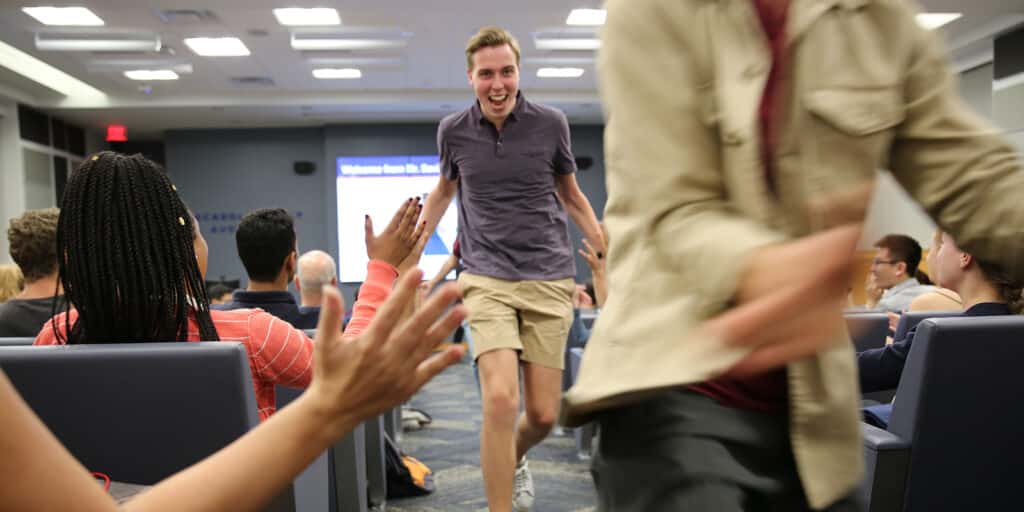 Students from UF Warrington's BSBA in Marketing program high-five each other after winning a competition