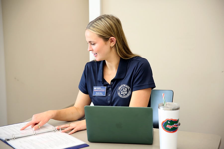 CAP Mentor sitting with her laptop and notes.