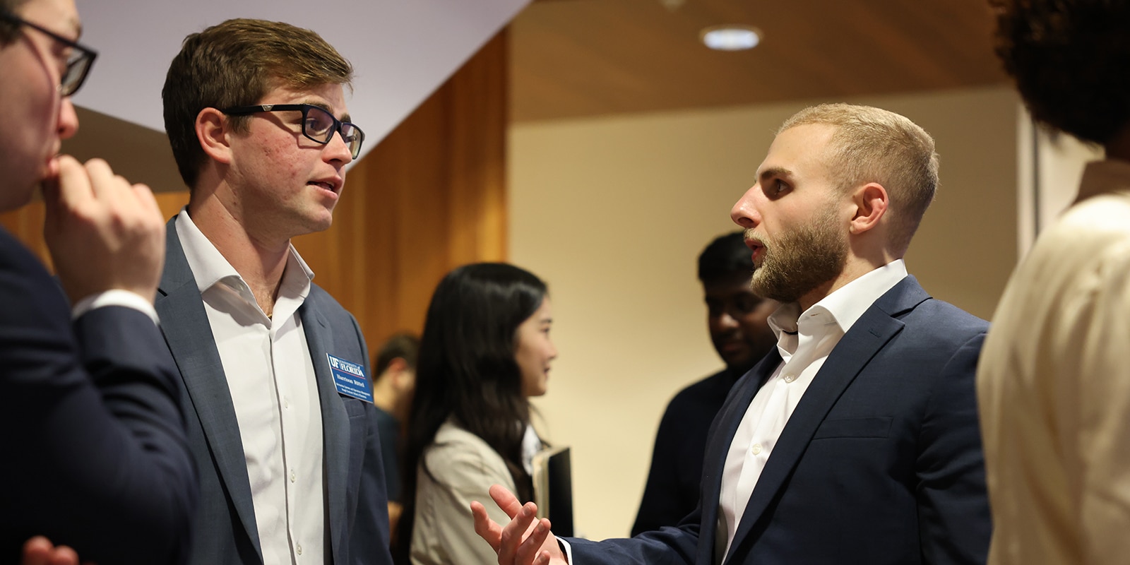 Student speaking with a recruiter at a career event.
