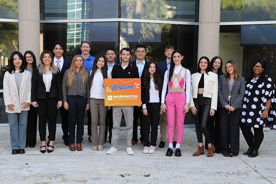 Group of students posed in front of Hough Hall. 