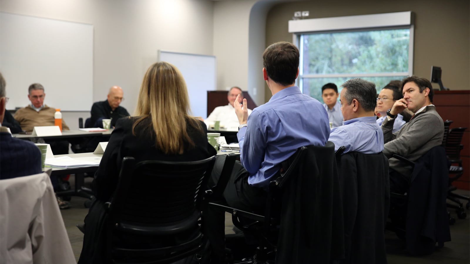 Group of event attendees gathered around a table. 