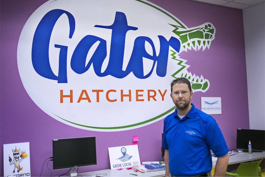 Jamie Kraft posing in the Gator Hatchery.
