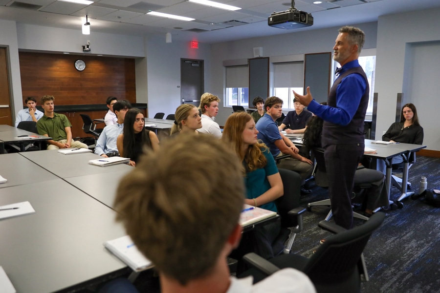 A classroom of students listens attentively as an instructor delivers an Excel seminar, teaching practical data skills for academic and professional success.