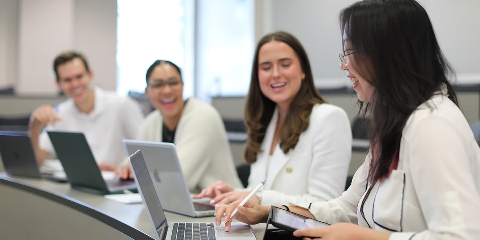 Happy students working together to fill out financial aid applications. 