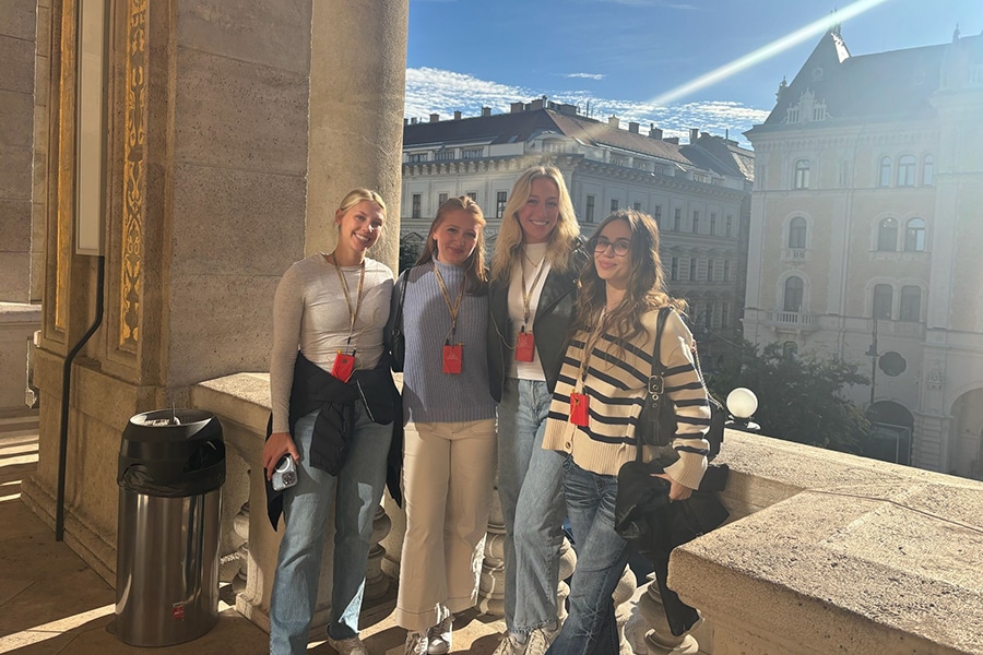 A group of female students posing during an international trip. 