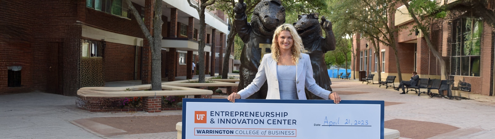 A student holding an oversized check from the Big Idea Competition.