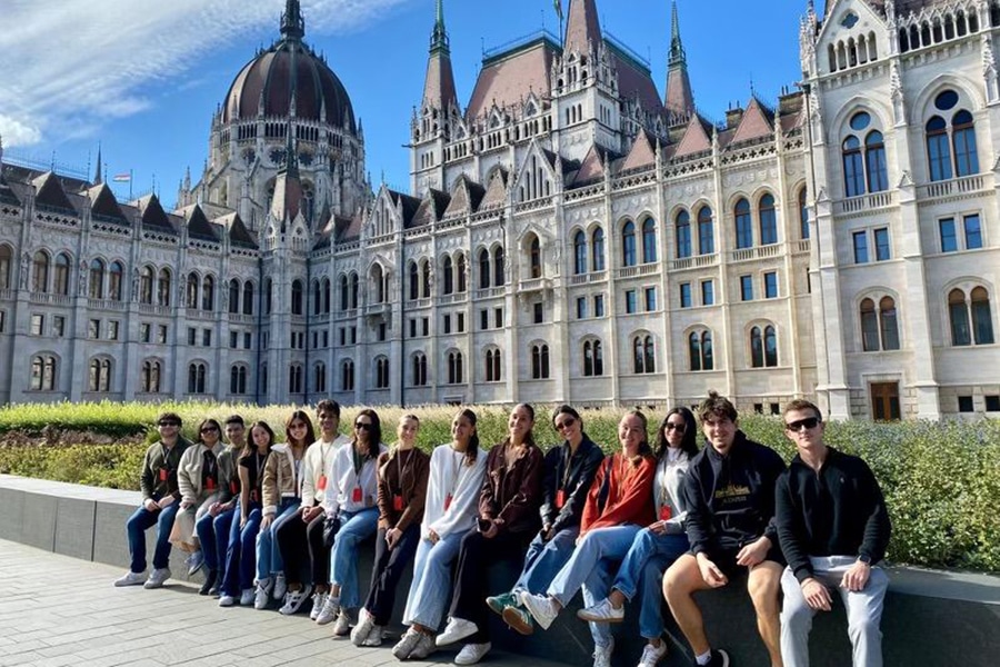 Group of students in front of a gothic building. 