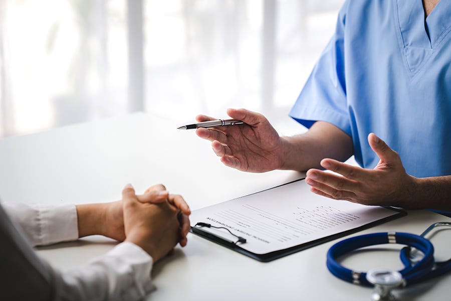 Patient and healthcare provider filling out forms. 