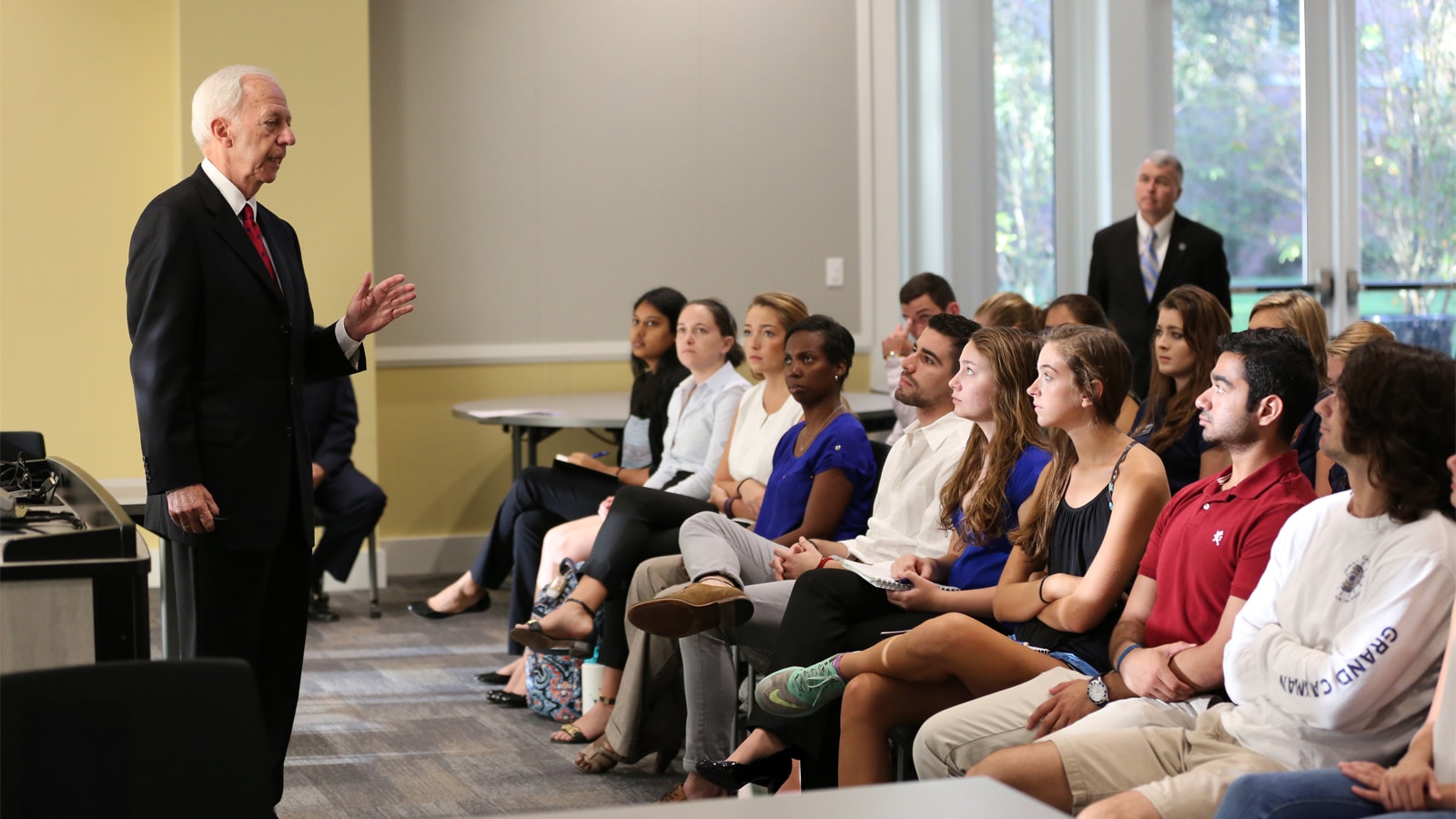J. Hyatt Brown, chairman of Brown and Brown, Inc., addresses students in a classroom at the University of Florida’s Warrington College of Business.