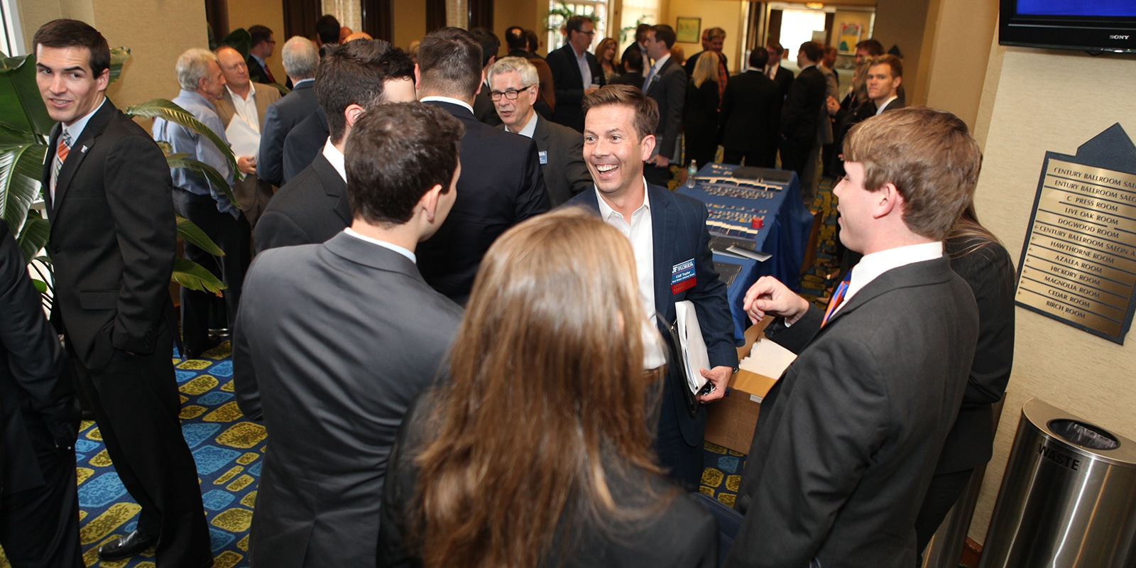 Students from UF Warrington's MS in Real Estate program speak and shake hands with industry professionals during a networking event