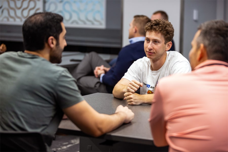 Students working together around a table. 