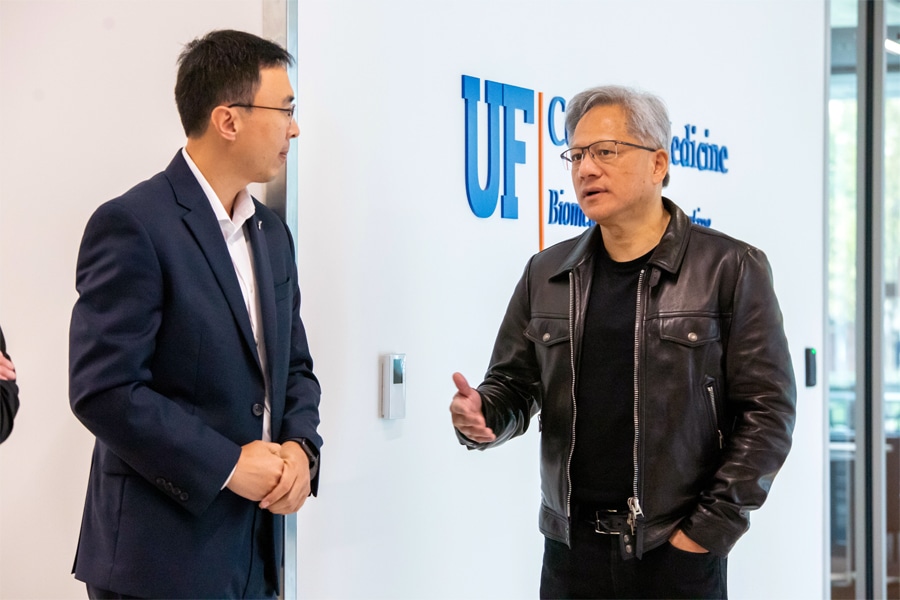Jensen Huang, CEO and co-founder of NVIDIA, gestures while speaking to a group in a classroom or workshop setting, engaging an audience of students and professionals.