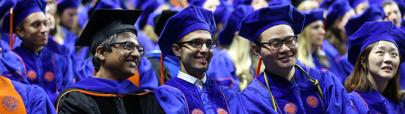 PhD in Accounting students in a row, in caps and gowns, during the University of Florida's commencement ceremony
